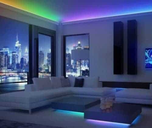 A white sofa and small table with the coloured light