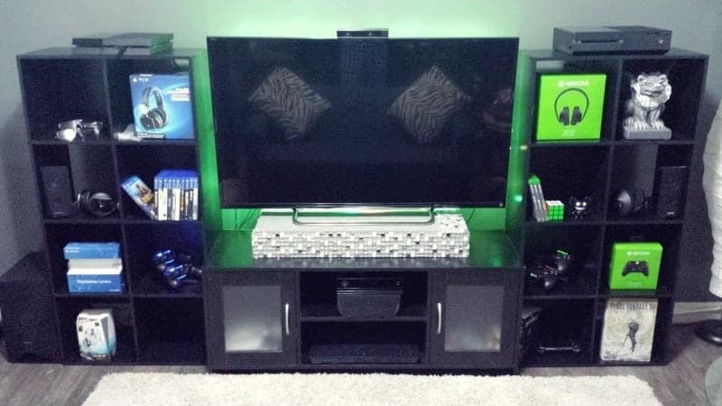 A big TV is on the stand and stuff around