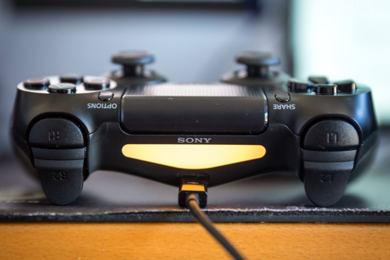 PS4 controller is charging on the table